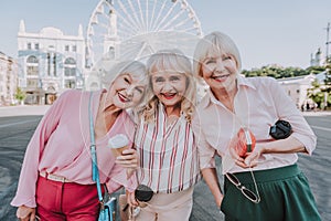 Three older women are spending time on square