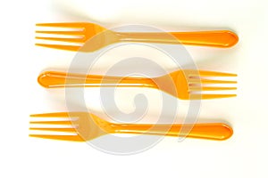 Three orange forks