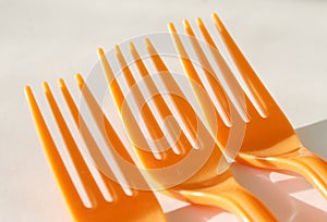 Three orange forks