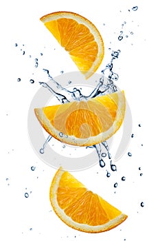 Three orange slices flying in splashing water  isolated
