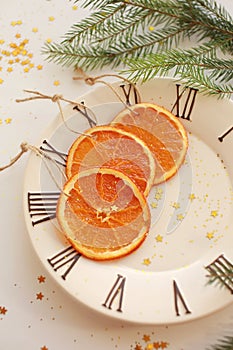 Three orange slices on the plate on light background.