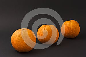 Three oranges on a black background