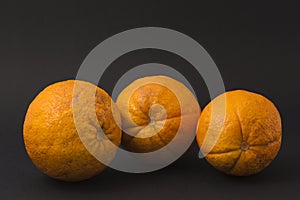 Three oranges on a black background