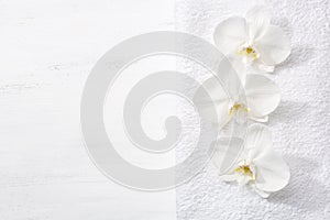 Three orchids and white terry towel