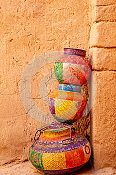 Three ornated traditional decorated arabic jars standing on each other on street of Al Ula, Medina province