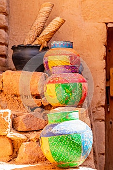 Three ornated traditional decorated arabic jars standing on street of Al Ula