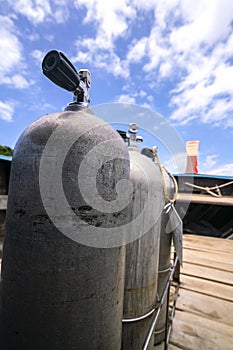 A three oxygen tanks for scuba diving ready with blue sky background