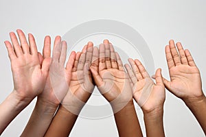 Three pairs of hands raised up