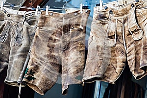 Three pairs of lederhosen drying on a line