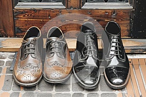 Three Pairs of Mens Shoes on a Wooden Floor. Generative AI