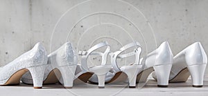 Three pairs of stylish white high heel shoes