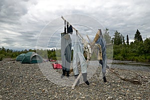 Three pairs of waders hanging out to dry photo