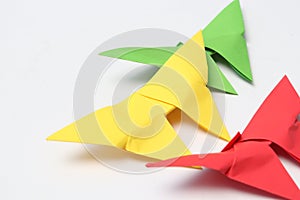 Three paper butterflies in red, green and yellow.