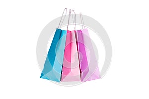 Three paper pink, purple,blue shopping bags isolated. Top view
