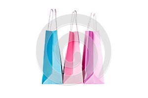 Three paper pink, purple,blue shopping bags isolated. Top view