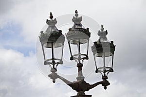 three Parisian street lamps