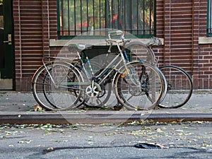 Three Parked Bicycles at Street in City