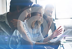 Three partners making research for new business direction. Business people meeting concept. Blurred background. Cropped. photo