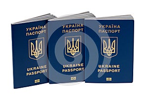 Three passports of Ukrainian citizens or migrants for visa-free travel to the European Union isolated on a white background.
