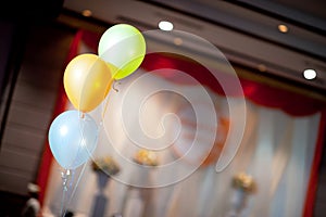 Three pastel balloons decorated in the wedding hall