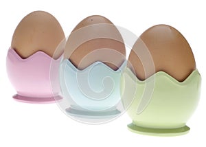 Three Pastel Egg Cups with Brown Eggs