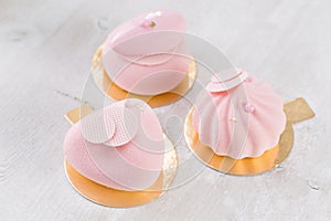 Three pastel pink cake on white wooden table. Little dessert served with tea or coffee. wallpaper, Horizontal photo