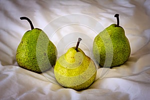 Three pears on a fabric.