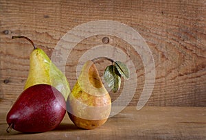 Three pears on a wooden plank