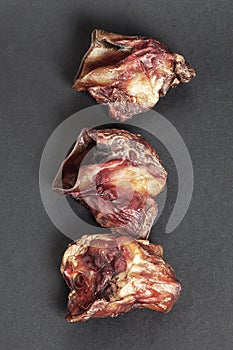 Three peices of dried beef larynxes used in exotic cuisine or as natural chewy treats for dogs.