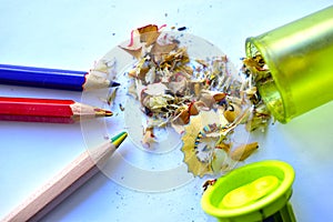 Three pencils and a garbage picker on a white background