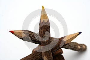 Three pencils made of a natural tree on a piny cone