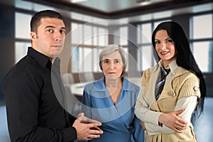 Three people dressed casually in the conference room