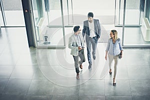 Three people entering the business building.