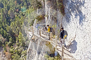Three people hiking in Montfalco footpath in the mountain photo