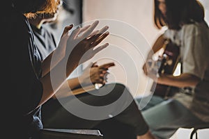 Three people pray and praising God together