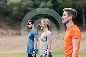 Three people standing doing an outdoor yoga session