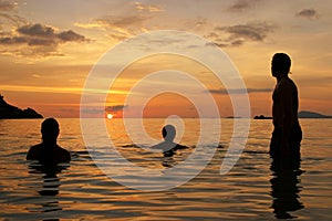 Three people waiting for the sunset