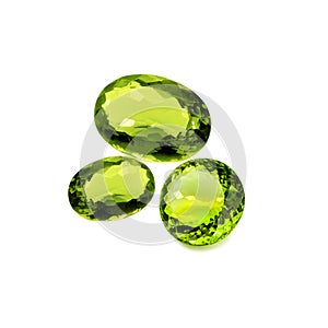 Three peridot stones on a white background