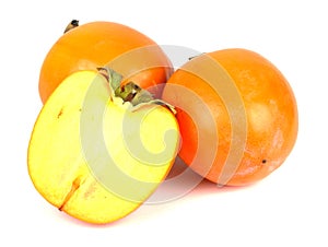 Three persimmons on white background.