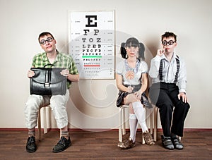Three person wearing spectacles in an office at the doctor