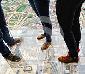 Three persons on the skydeck in Chicago