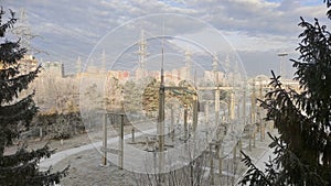 Three-phase high-voltage transformer of high electrical power at substation in electric power plant, winter snow view