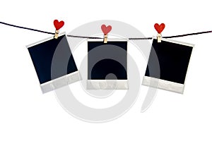 Three photoframes with red heart clothepins