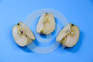 Three pieces of apple on blue background