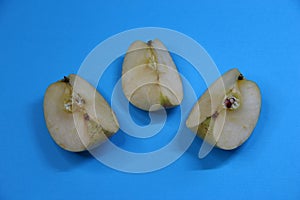 Three pieces of apple on blue background