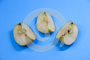 Three pieces of apple on blue background