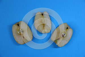 Three pieces of apple on blue background