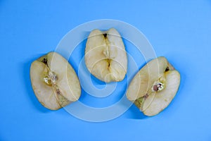 Three pieces of apple on blue background