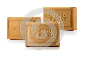 Three pieces of brown laundry soap on a white background. Full depth of field.