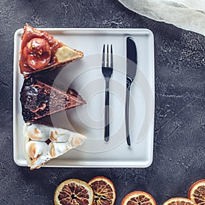 Three pieces of different cakes on plate